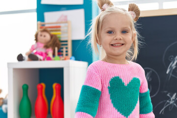 Adorable caucasian girl smiling confident standing at kindergarten