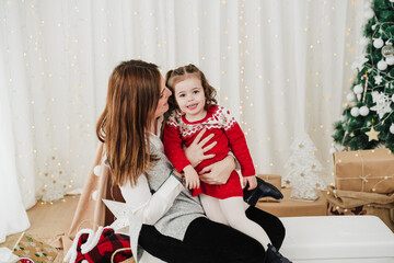 happy mother and daughter at home enjoying christmas time at home