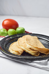 Traditional Mexican food, corn tortilla quesadillas, stuffed with cheese.