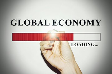 Business Woman hand with glitter nails showing the Loading Bar with the text “Global Economy”