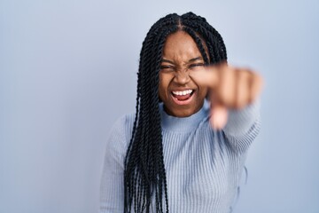 African american woman standing over blue background pointing displeased and frustrated to the camera, angry and furious with you