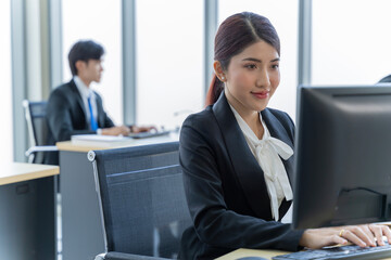 Fototapeta premium A group of young Asian businessmen Talking and planning work happily and have fun. at the company's office