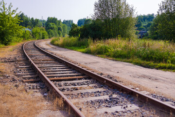 Railway tracks on a summer day and a view of the station