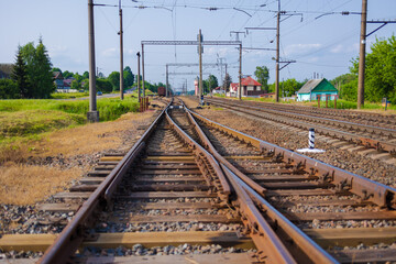 Fototapeta na wymiar Railway tracks on a summer day and a view of the station
