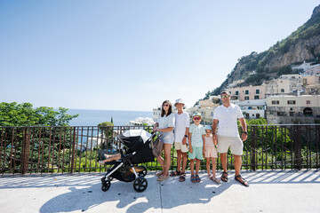 Large family tourist with four kids at famous village Positano on vacation in Italy.