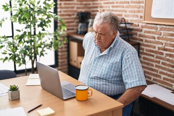 Middle age grey-haired man business worker suffering for backache at office
