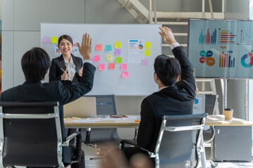 A group of young Asian businessmen Talking and planning work happily and have fun. at the company's office