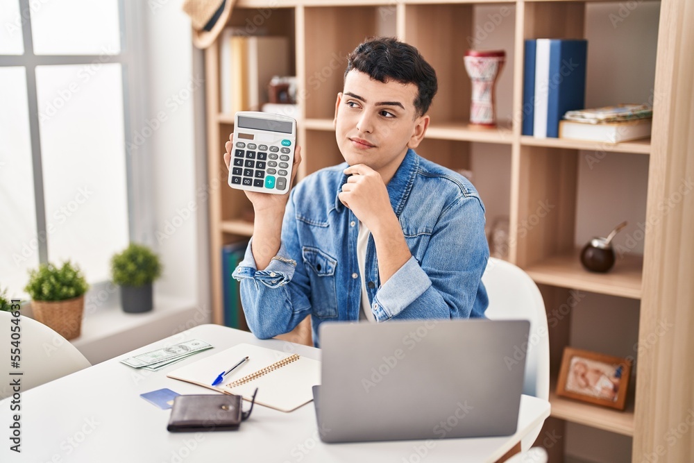 Canvas Prints Non binary person calculating money savings serious face thinking about question with hand on chin, thoughtful about confusing idea