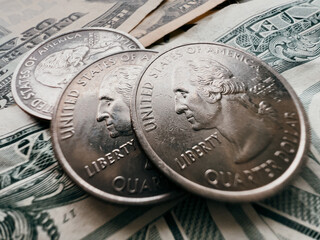 Close up shot of US money on the table. Macro shot of the American cents and green dollars. A green federal reserve note. Liberty portrait on the quarter dollar 