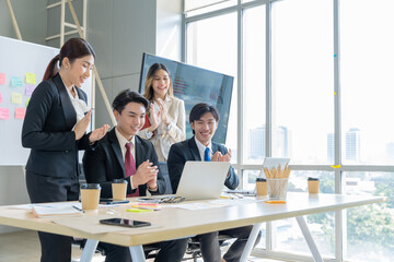 A group of young Asian businessmen Talking and planning work happily and have fun. at the company's office