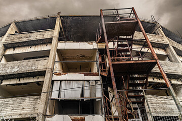 abandoned unfinished building against cloudy sky