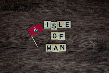 Fototapeta na wymiar Isle Of Man - wooden word with isle flag (wooden letters, wooden sign)