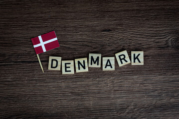 Fototapeta na wymiar Denmark - wooden word with danish flag (wooden letters, wooden sign)