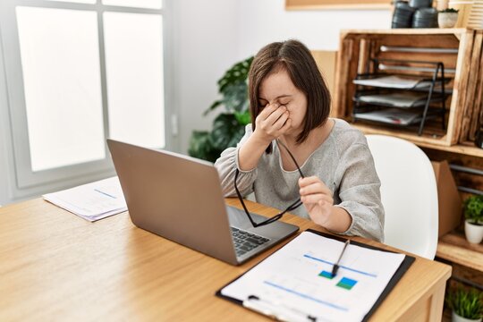 Brunette Woman With Down Syndrome Working Tired At Business Office