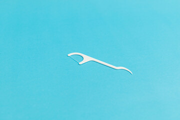 Floss with handle on blue background