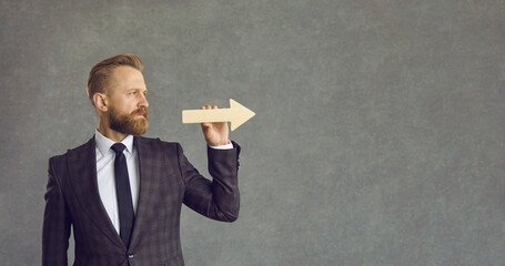 Businessman going in right direction. Side view serious confident young man in suit holding graph...