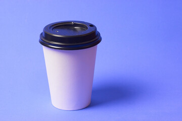 one glass of takeaway coffee on a blue background