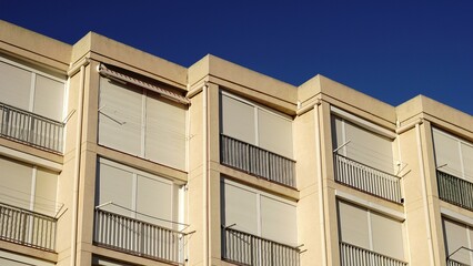 building facade with lowered window shutters