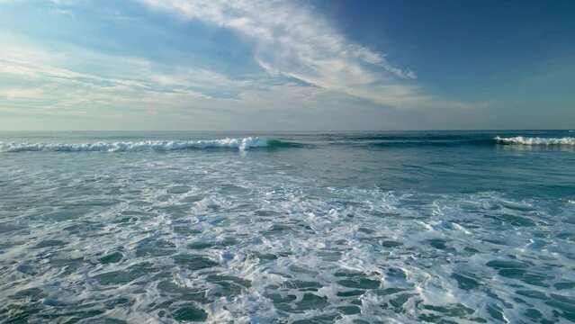 Waves Approaching On The Shore With Blue Sky At Background In Caion, Galicia, Spain. Aerial Drone Shot