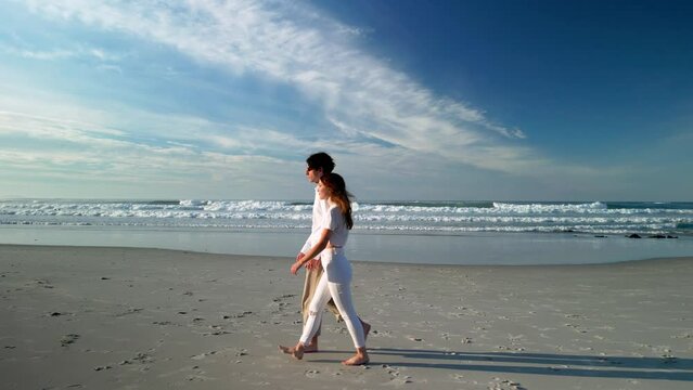 Romantic Pair Strolling On Seashore At Sunset In Caion Beach, Spain. Tracking Shot
