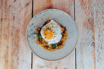 Fried egg on top of a bean stew 