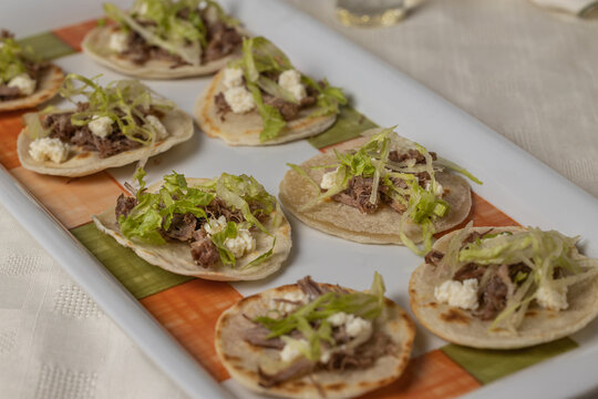 Close up of Chalupas, Typical Mexican dish made with tortillas, sauce, cheese, meat and lettuce.