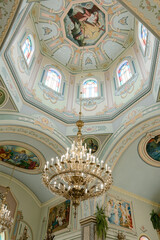 Obraz premium The central dome in the church with a large chandelier.