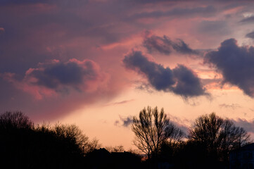 Dramatic sunset with dark clouds and glimpses of light.