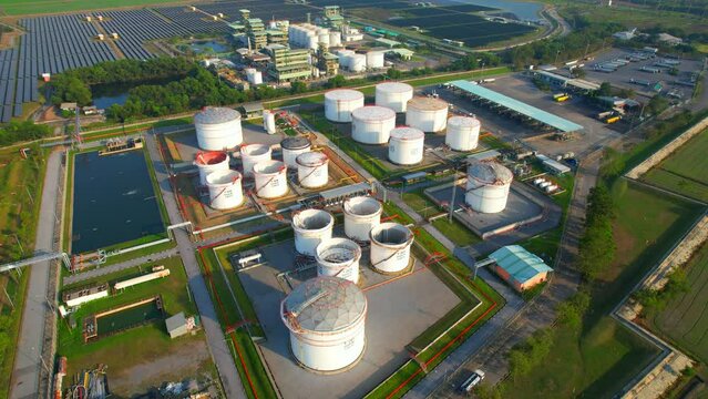 Drone flying above a large oil storage tanks on the ground. crude, ULG and diesel oil storage tanks. Fossil fluid used to drive combustion engines. Business power and energy industry. Aerial view. 4K
