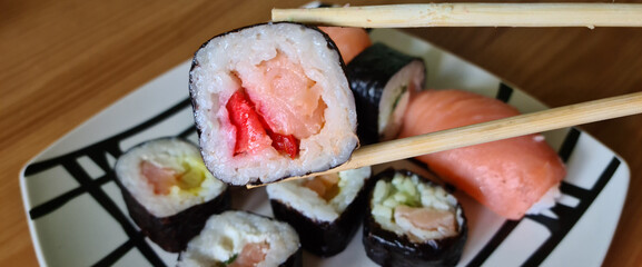 Set of delicious sushi rolls on a plate closeup