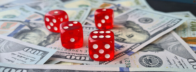 Dice and dollar banknotes on laptop keyboard. Online casino and online gambling c