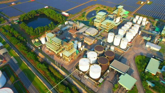 Drone flying above a large oil storage tanks on the ground. crude, ULG and diesel oil storage tanks. Fossil fluid used to drive combustion engines. Business power and energy industry. Aerial view. 4K
