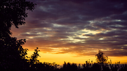 Climatic landscape of sunset. Blue and  orange clouds.