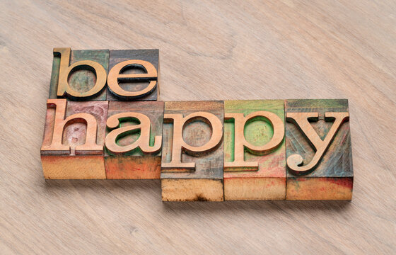 be happy word abstract in letterpress wood type, happiness, positive mindset and personal development concept