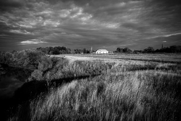 White house in norway. Lonely house in field in Scandinavian style at sunset.