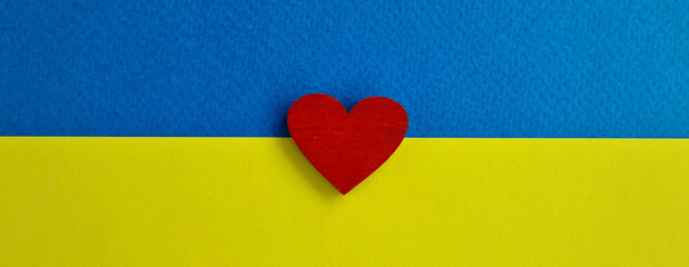 Ukraine flag and red heart help Ukraine closeup