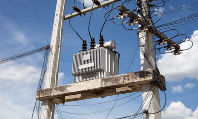 Cement high voltage electric pole power with transformer and drop fuse.