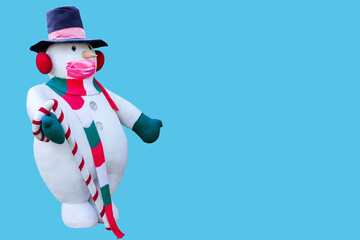 snowman doll isolated on blue background.