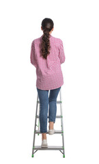 Young woman climbing up metal ladder on white background, back view © New Africa