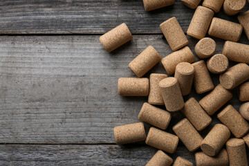 Wine bottle corks on wooden table, flat lay. Space for text