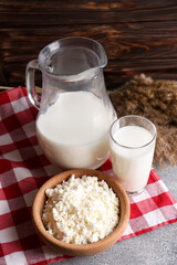 Obraz na płótnie Canvas Tasty fresh milk and cottage cheese on grey table