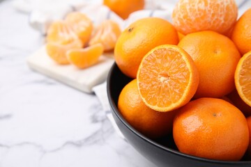 Fresh juicy tangerines on white marble table, closeup. Space for text