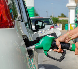 Fuel crisis and oil price. Woman refueling diesel at a gas station