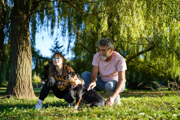 The grandfather, granddaughter and dog in the nature.