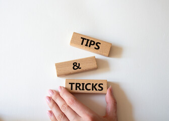 Tips and tricks symbol. Wooden blocks with words Tips and tricks. Beautiful white background....