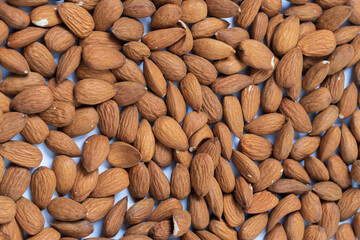 Unshelled almonds spread on a uniform surface