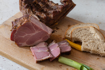 Smoked meat to eat on a white table. A good snack.