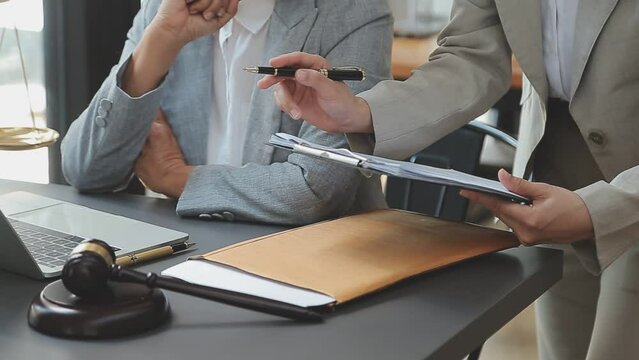 Business and lawyers discussing contract papers with brass scale on desk in office. Law, legal services, advice, justice and law concept picture with film grain effect