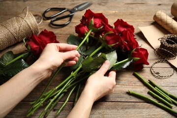 Fototapeta na wymiar Woman making luxury bouquet of fresh roses at