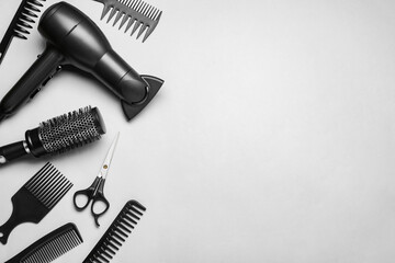 Fototapeta na wymiar Flat lay composition of professional hairdresser tools on white background, space for text